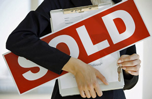 sold-sign-held-in-arms