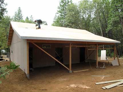 Nailing off the roof sheathing before laying plastic over the roof for temporary protection for the next few days of rain 