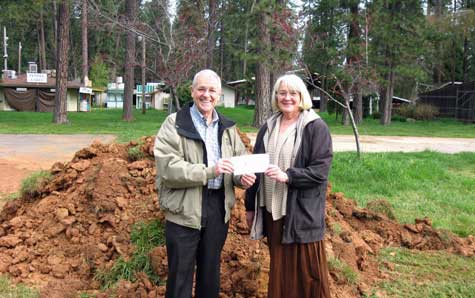Ed Scofield, President of the Nevada County Fairgrounds Foundation, presents a $30,000 check to Fairgrounds CEO Sandy Woods.  With the elimination of state funding to the Fairgrounds, the Foundation plays an increasingly critical role in supporting the Fairgrounds, especially with infrastructure projects.