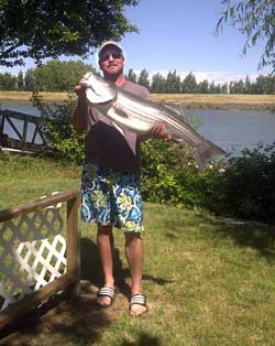 Doug with a nice striper caught at Snug Harbor