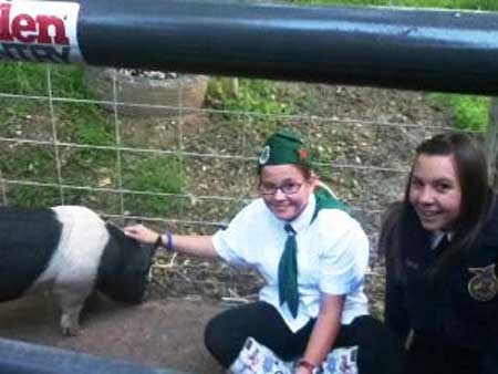 Preparing for the Junior Livestock Auction on Sunday of the Fair are (from left to right): Zoe Fink, who donated the Heritage Hog; and Sierra Mitchell, who is raising the Heritage Hog for the Nevada County Fairgrounds Foundation. Photo credit: Nevada County Fair